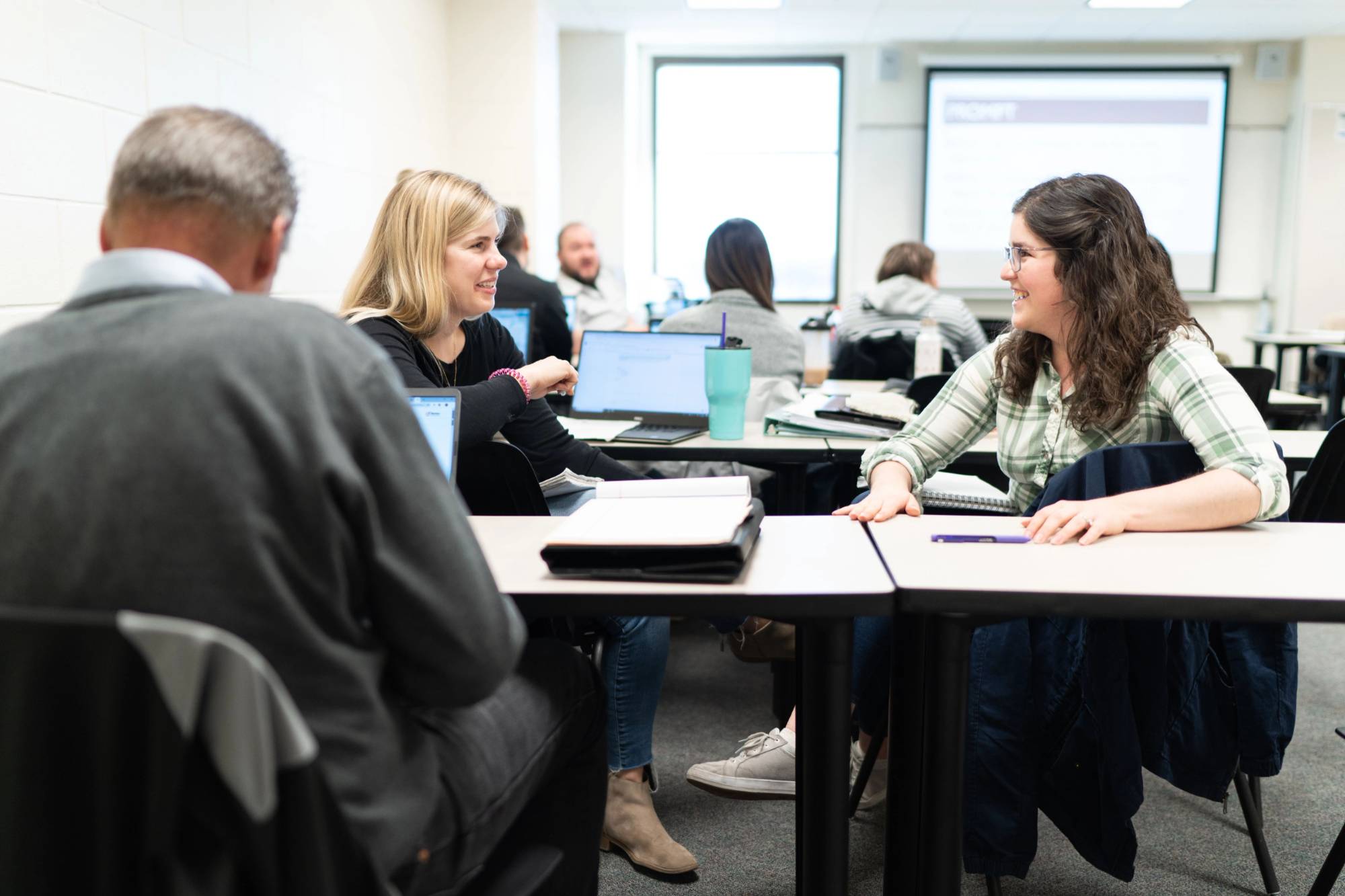 photo of students and faculty working together at classroom table